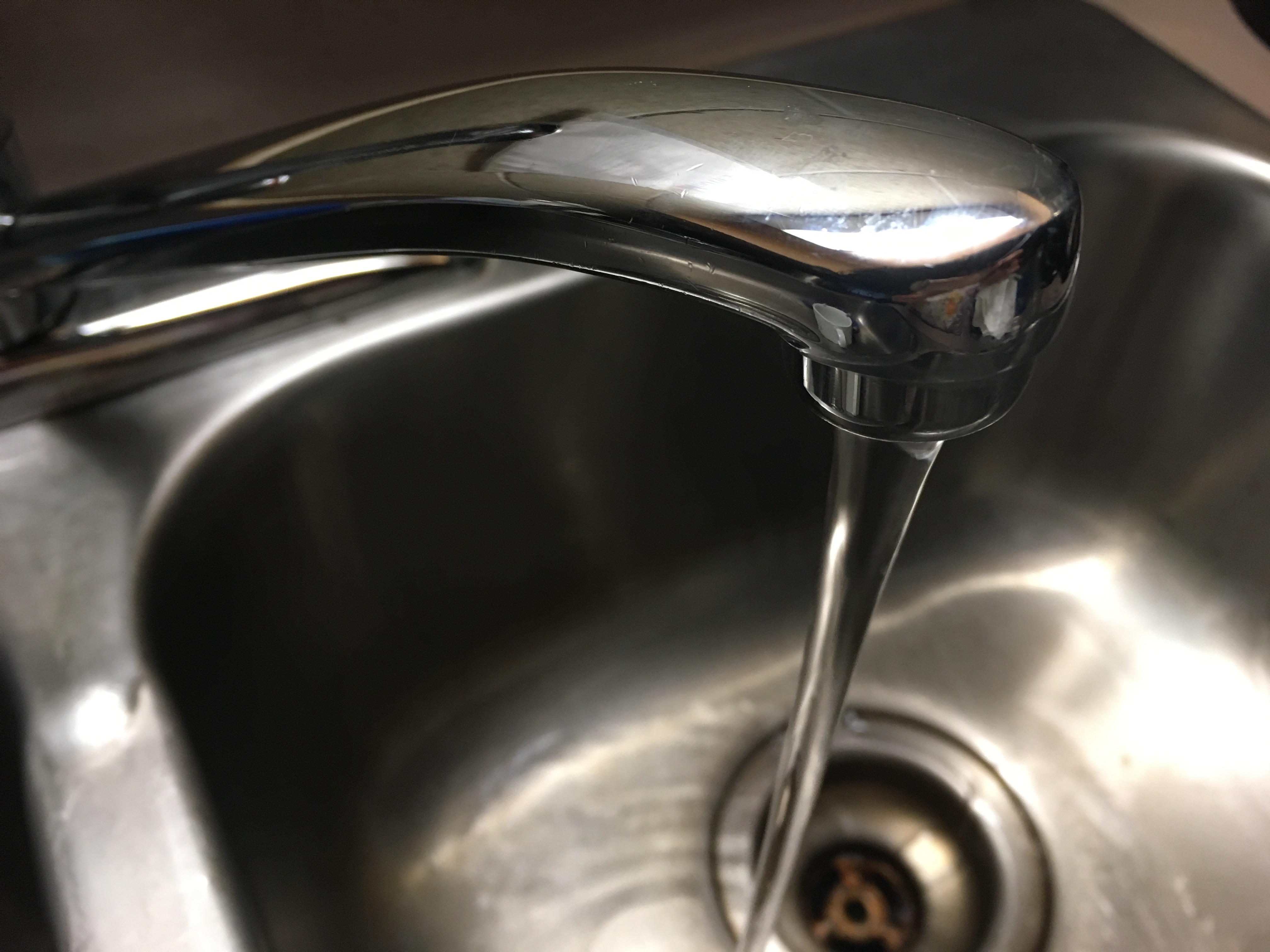 picture of water coming out of a simple kitchen faucet
